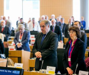 Members of the Committee of the Regions standing in tribute to victims of the Brussels attacks